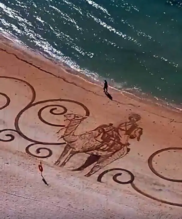 dubai camel sand art on beach