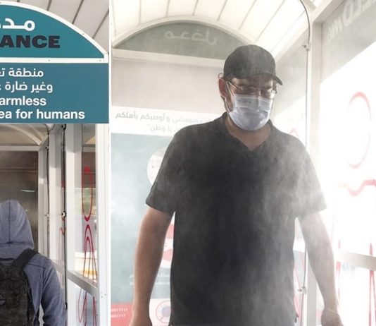 Passengers Get Sprayed at Disinfection Gate in Bus Station